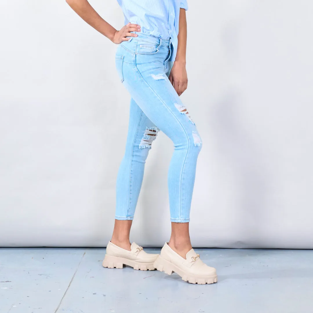 Distressed skinny jeans with ripped details wholesale
