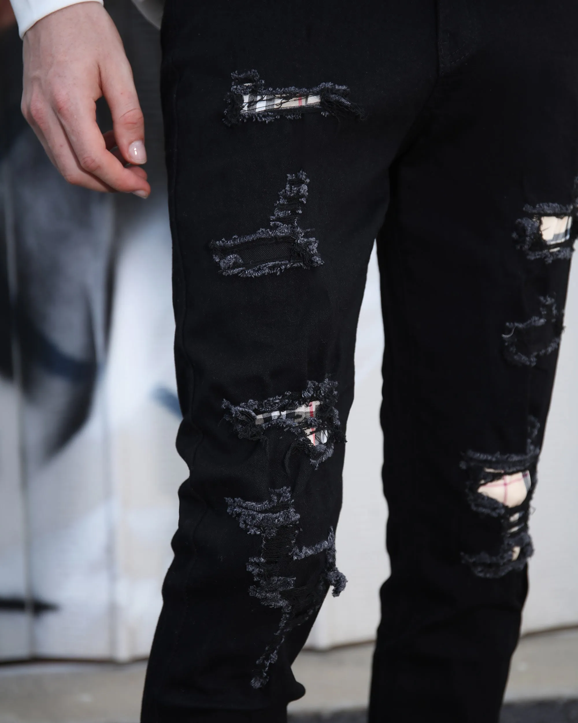 Simple & Stylish Black Ripped Jeans with Classic Plaid Patch