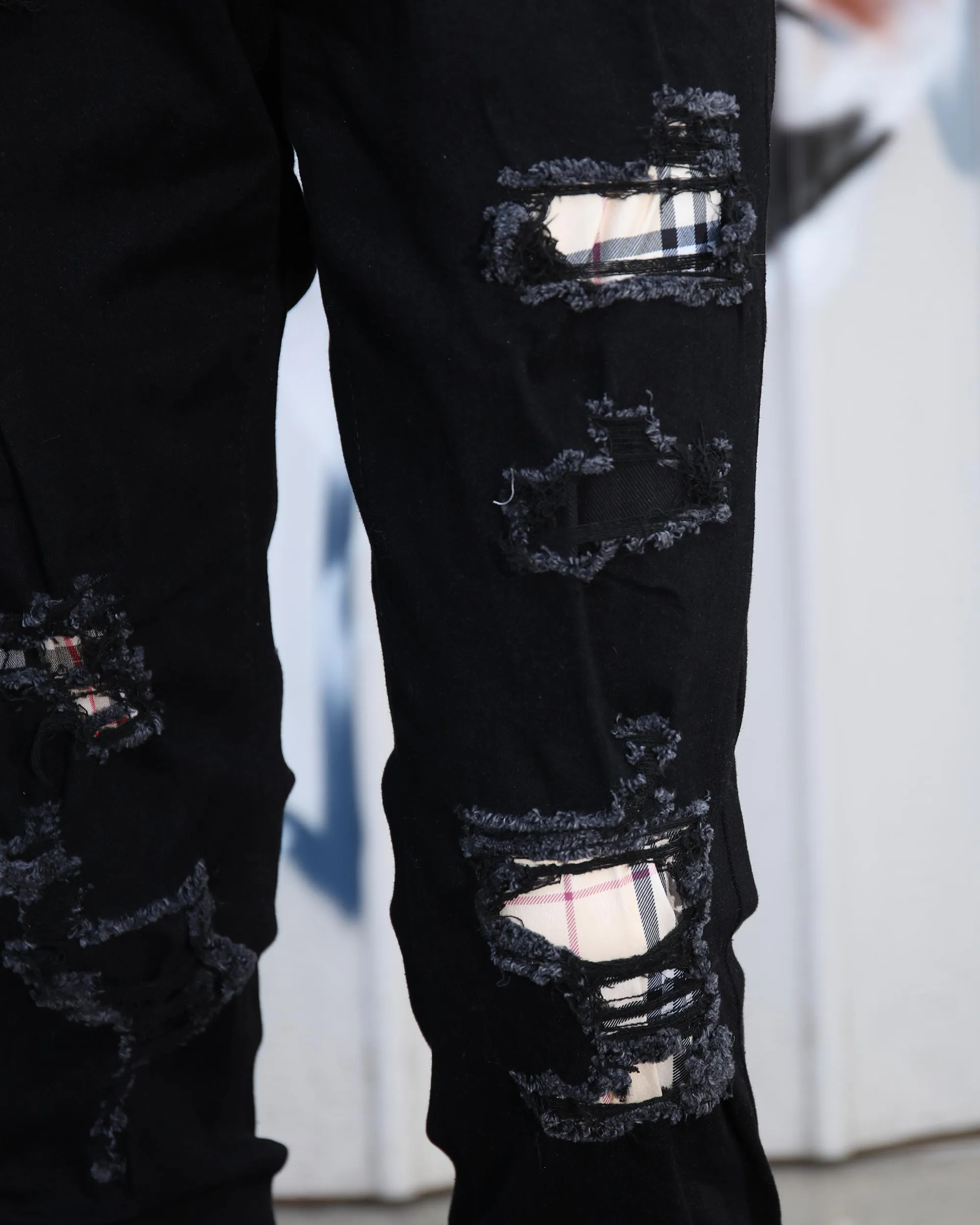 Simple & Stylish Black Ripped Jeans with Classic Plaid Patch