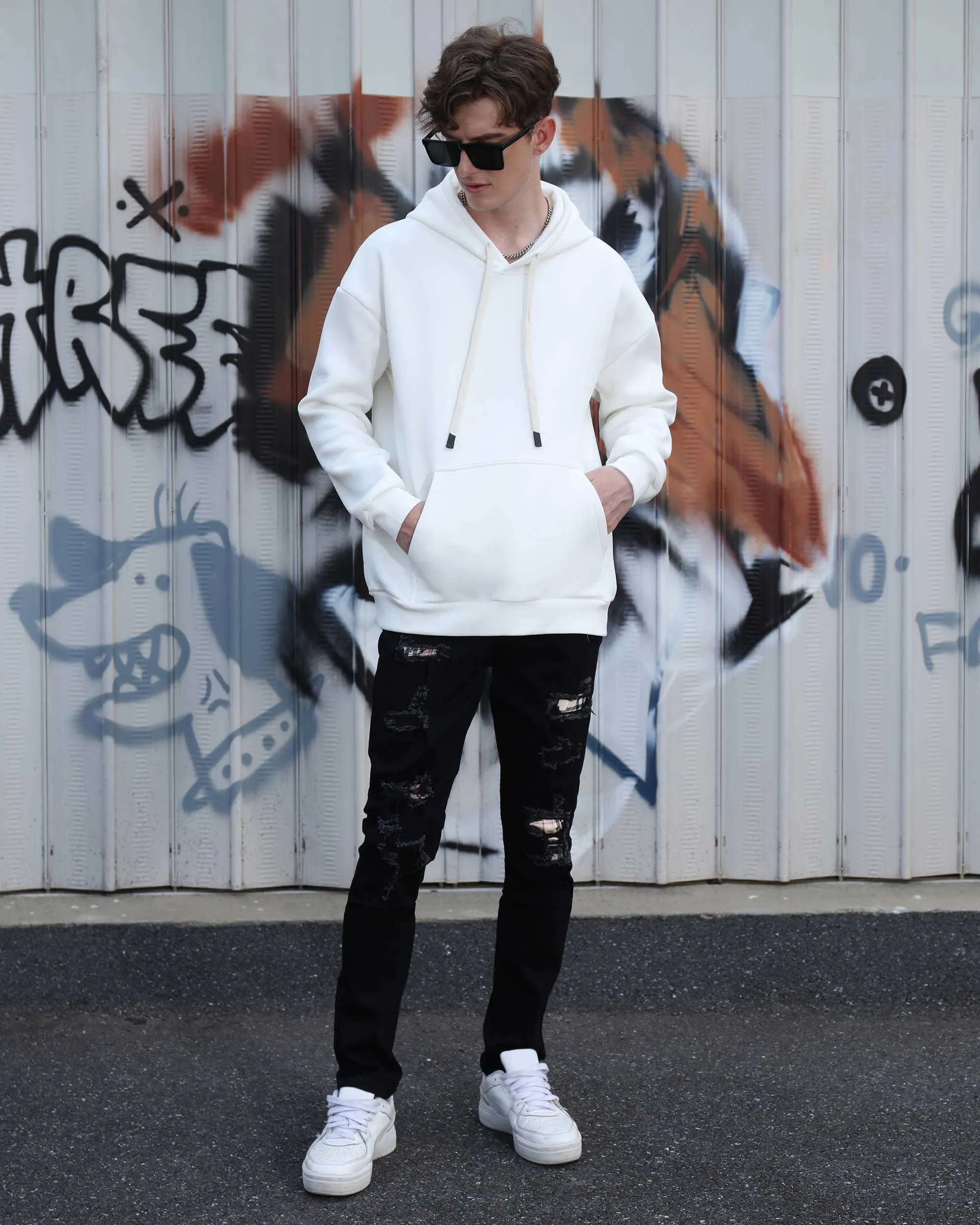 Simple & Stylish Black Ripped Jeans with Classic Plaid Patch